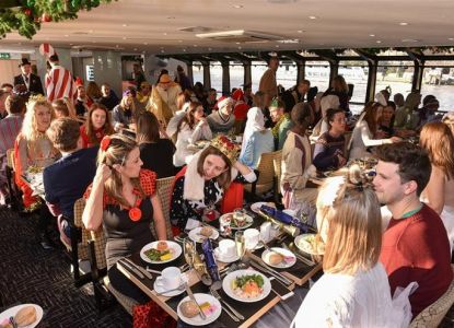 Ospiti al pranzo di Natale nel salone riscaldato del battello sul Tamigi